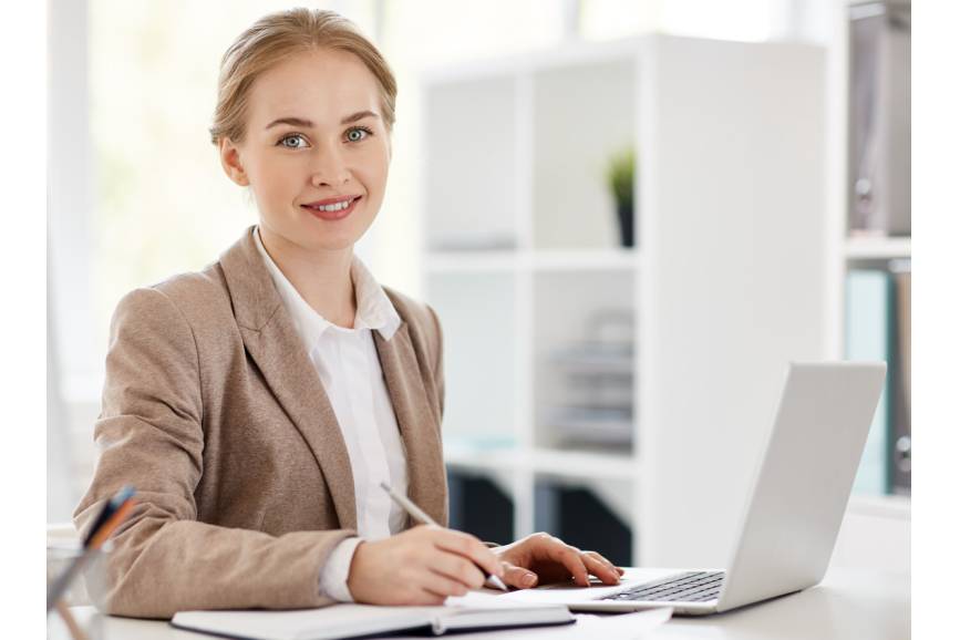 Na zdjęciu kobieta siedząca przed laptopem